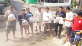 Sekdes Kretek Edi Setia Budi menunjukkan benih ikan sebelum ditebar ke Kali Susukan, Minggu (7/12/2025). Pemdes Kretek menebar 3.600 benih ikan lele, melem, dan mujair untuk melestarikan ekosistem sungai sekaligus mengurangi kecanduan gawai pada anak-anak. Foto: Istimewa.